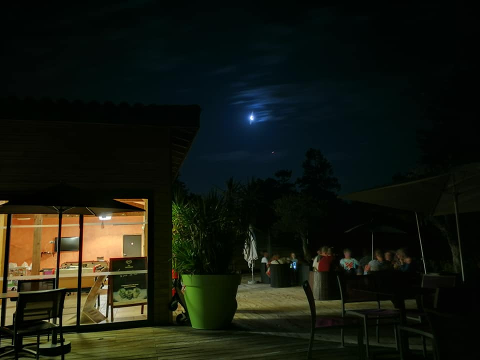Moonlit terrace under a deep blue night sky