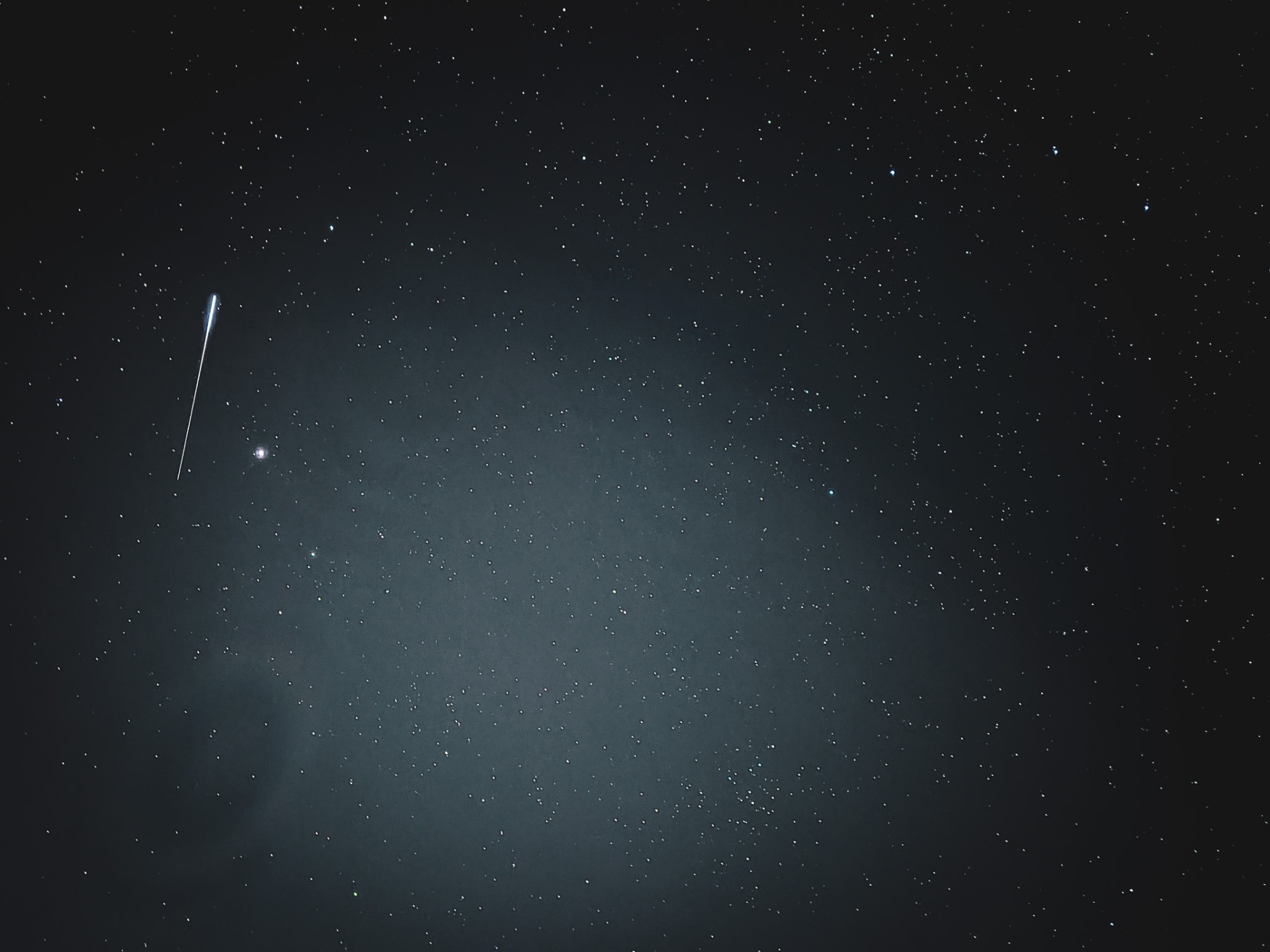Meteor streaking through a star-filled night sky